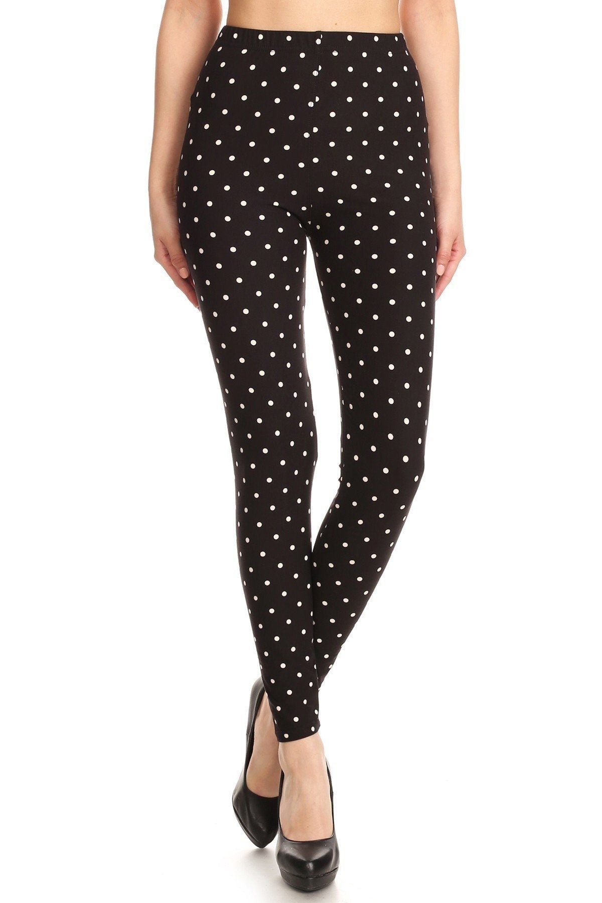 High Waisted Leggings With An Elastic Band In A White Polka Dot Print Over A Black Background