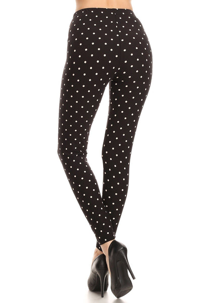 High Waisted Leggings With An Elastic Band In A White Polka Dot Print Over A Black Background